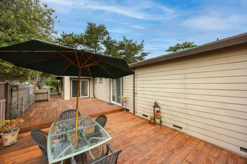 a view of a backyard with a patio and wooden floor