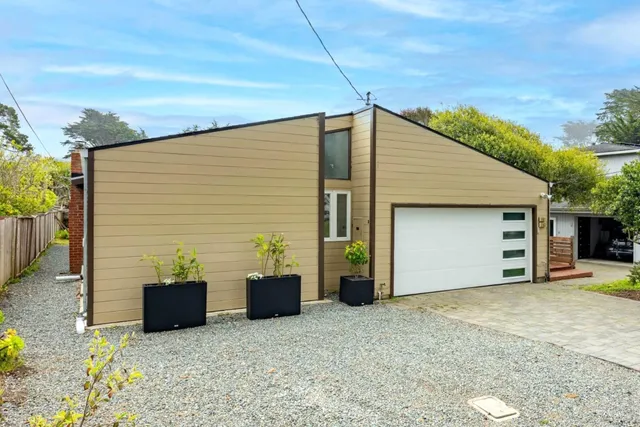 a backyard of a house with yard and garage