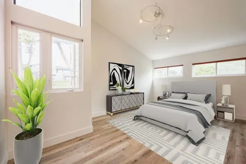 a bedroom with a bed a chandelier and couch