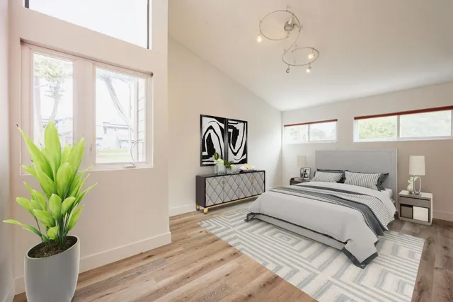 a bedroom with a bed a chandelier and couch