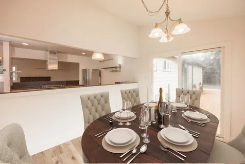 a dining room with furniture and wooden floor
