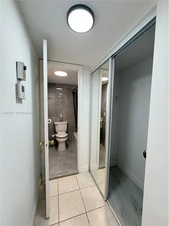 a view of a hallway with bathroom and a sink