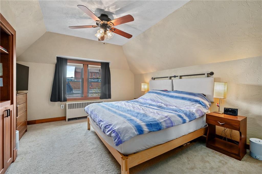219 Main Street Pittsburgh, PA 15201 - Photo 14 of 35 a bedroom with a bed and a chandelier