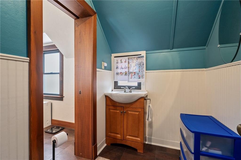 219 Main Street Pittsburgh, PA 15201 - Photo 16 of 35 a bathroom with a sink a mirror and a window