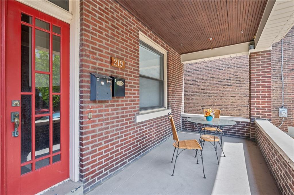 219 Main Street Pittsburgh, PA 15201 - Photo 3 of 35 a brick building with a bench and a barbeque