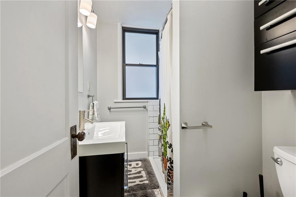 219 Main Street Pittsburgh, PA 15201 - Photo 9 of 35 a bathroom with a sink and a mirror