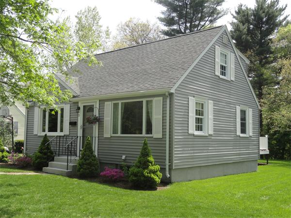 a view of a house with a yard and a garden