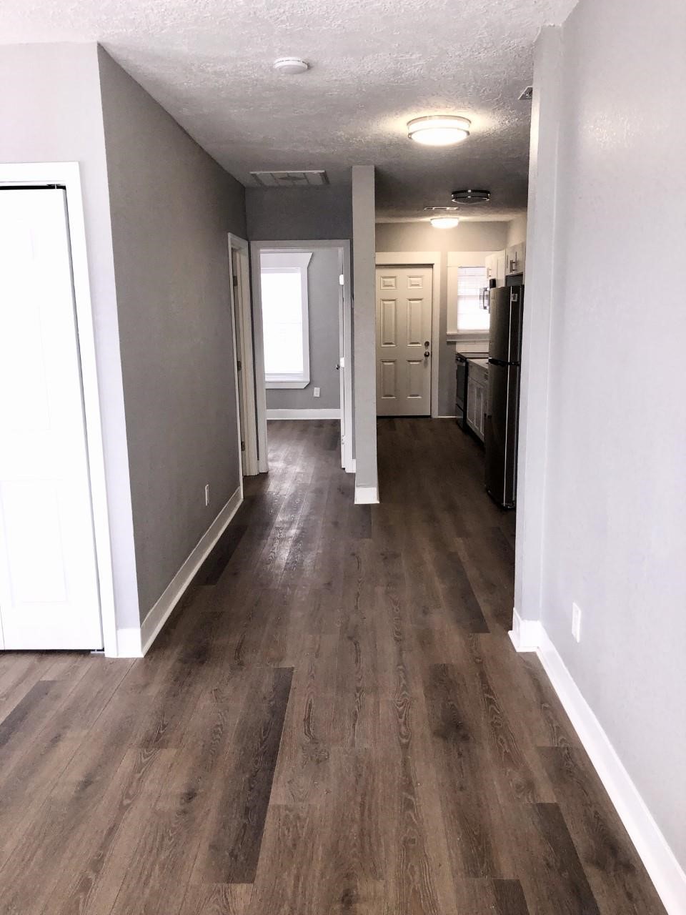 220 Milby Street Houston, TX 77003 - Photo 3 of 11 a view of a hallway with wooden floor