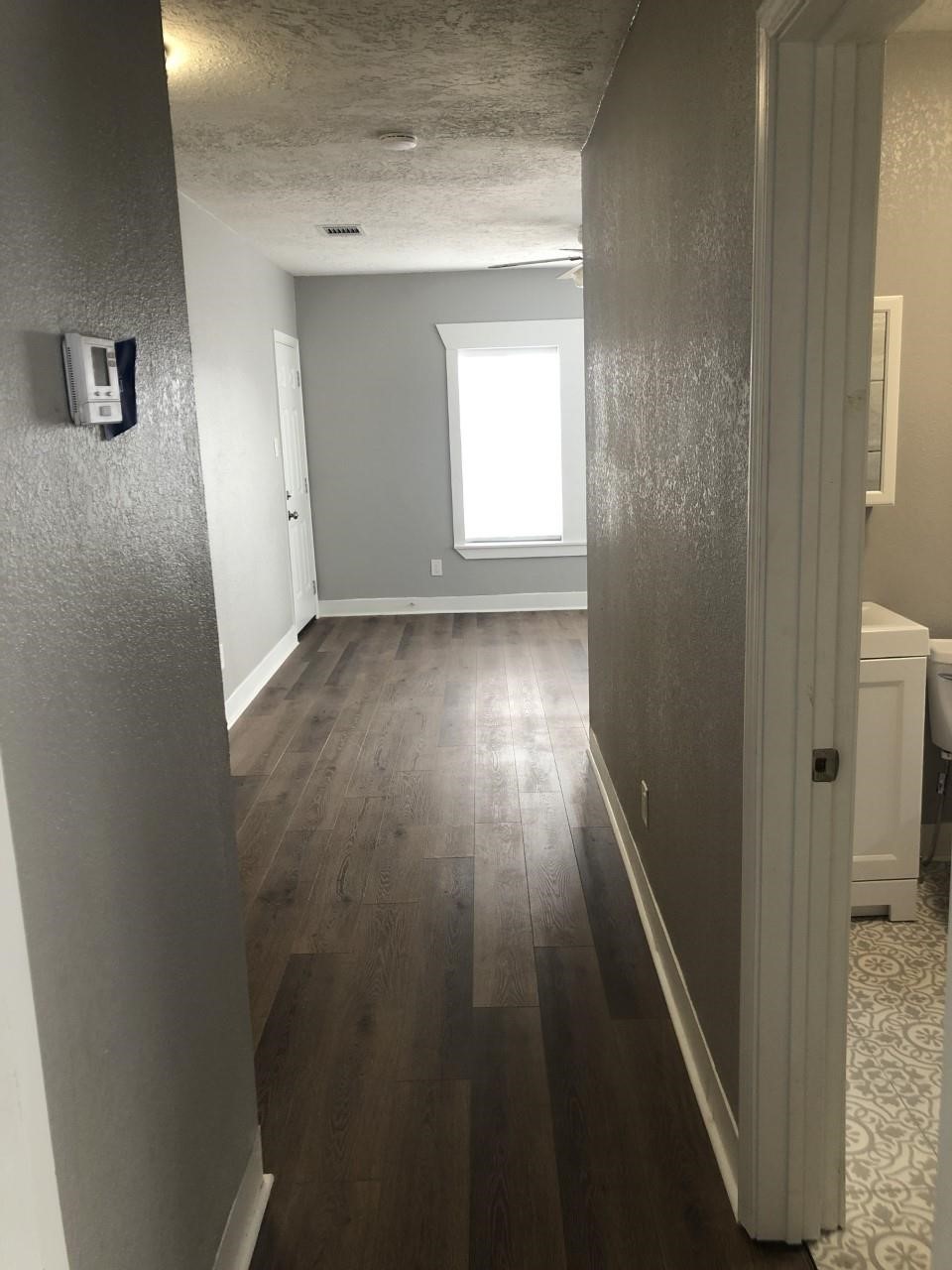 220 Milby Street Houston, TX 77003 - Photo 4 of 11 a view of a hallway with wooden floor and closet
