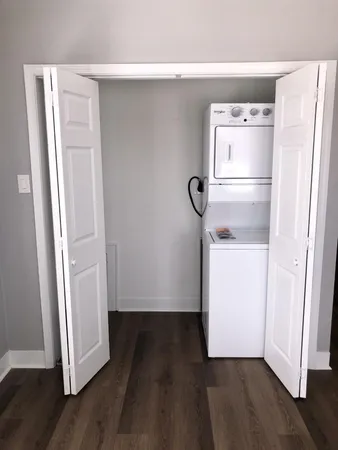 a view of empty room with wooden floor