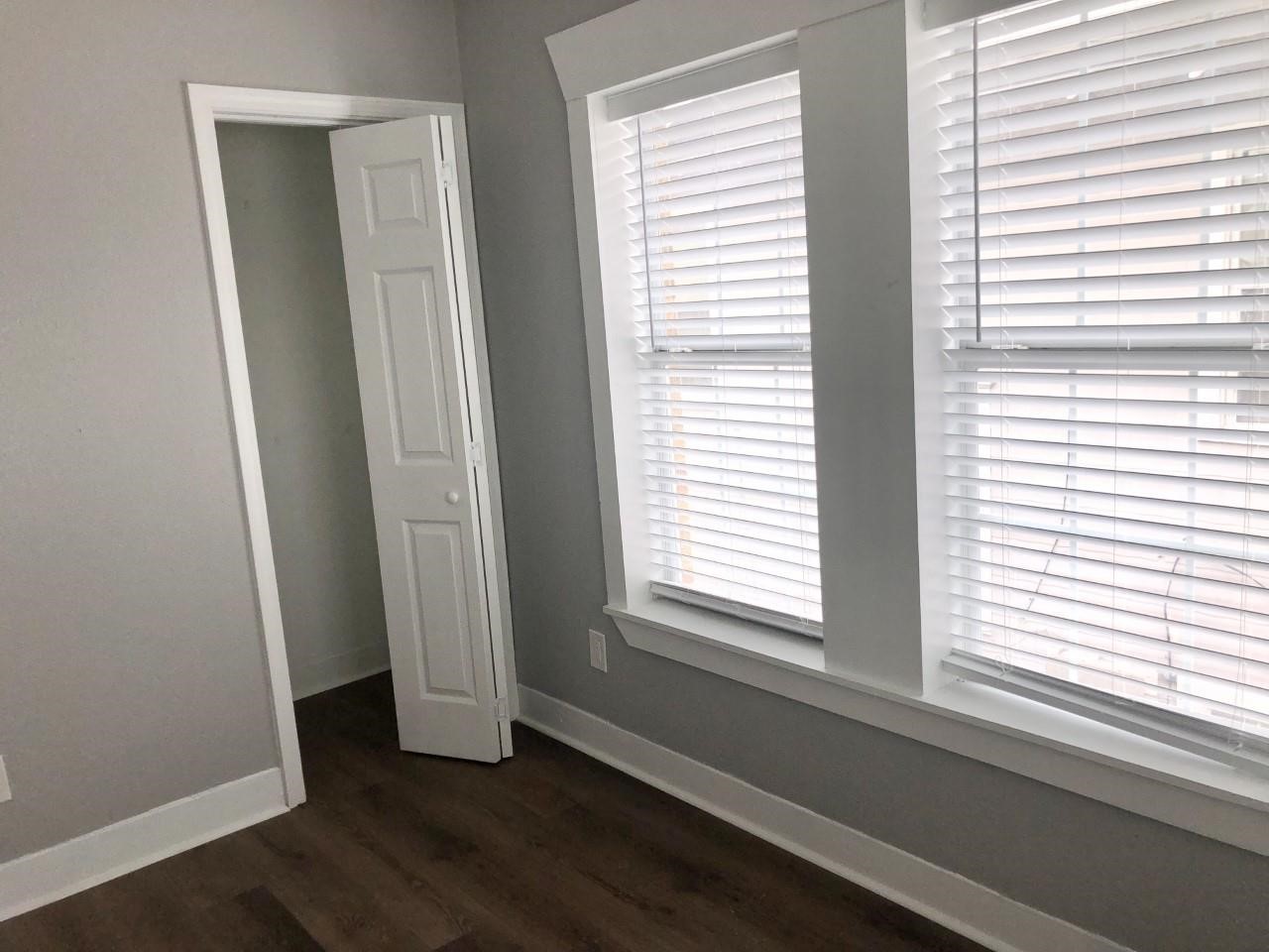 220 Milby Street Houston, TX 77003 - Photo 9 of 11 a view of an empty room with wooden floor and a window
