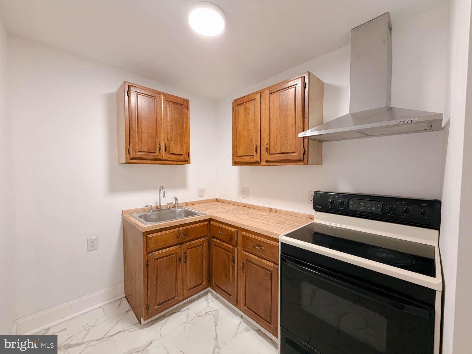 1050 Culvert Street Reading, PA 19602 - Photo 4 of 17 a kitchen with a sink stove and cabinets