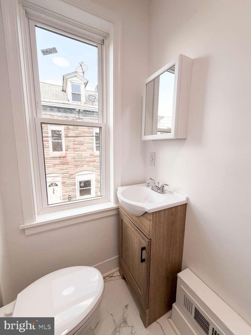 1050 Culvert Street Reading, PA 19602 - Photo 10 of 17 a bathroom with a sink a toilet and a mirror