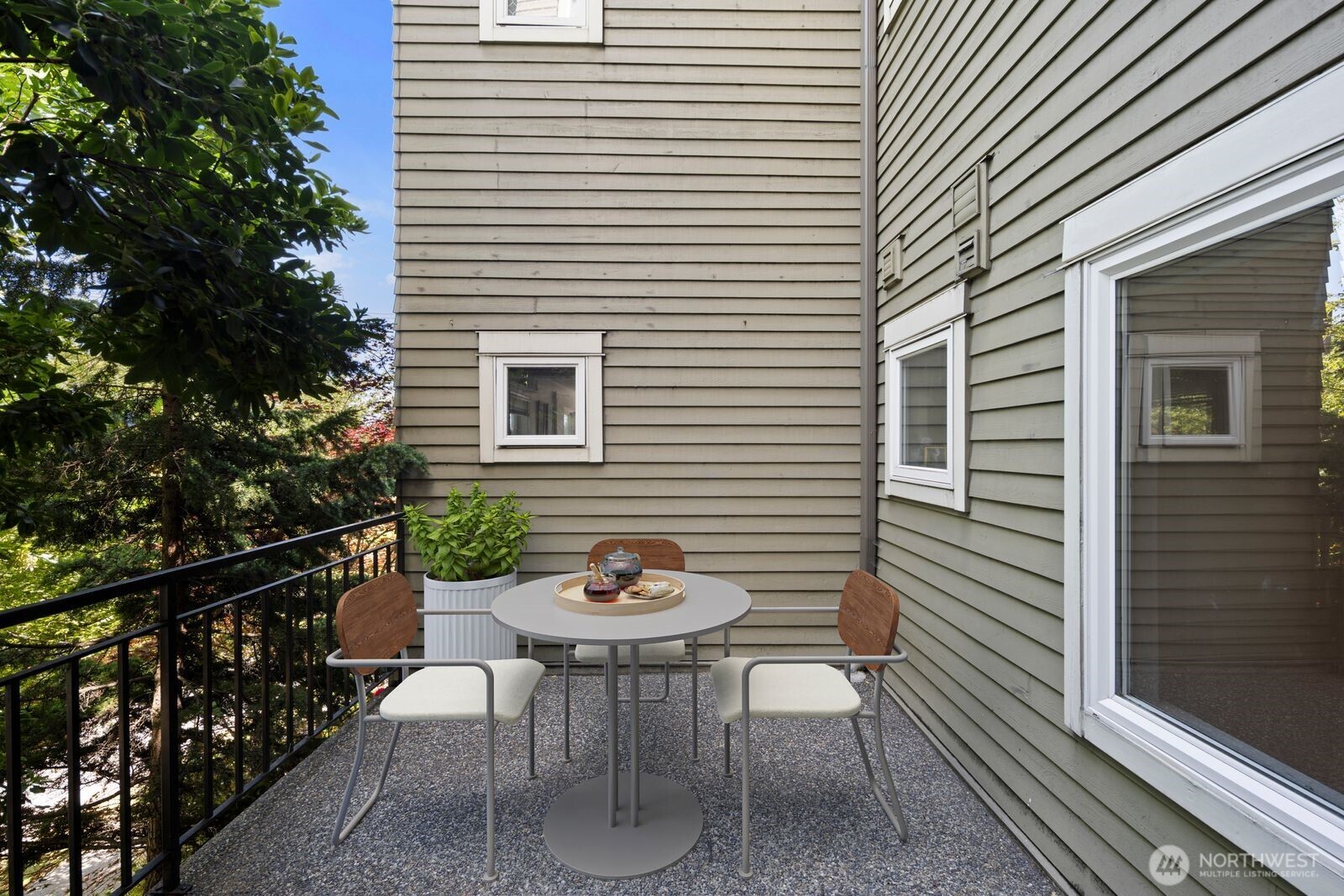 3901 Fremont Avenue North, Unit 202 Seattle, WA 98103 - Photo 5 of 23 a view of a patio with a table and chairs and a barbeque