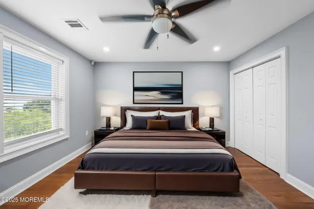 a bedroom with a bed and a large window