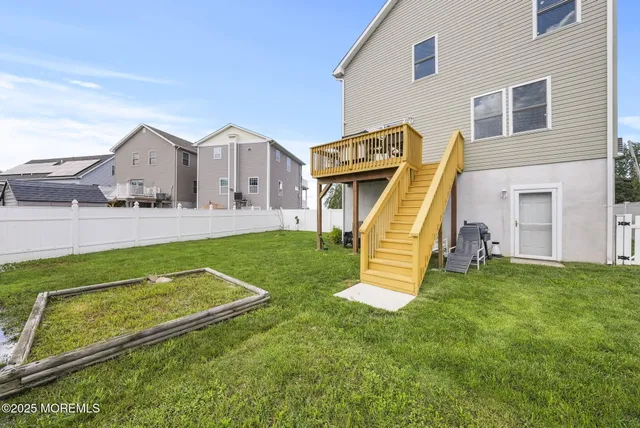 an aerial view of residential houses with outdoor space and trees