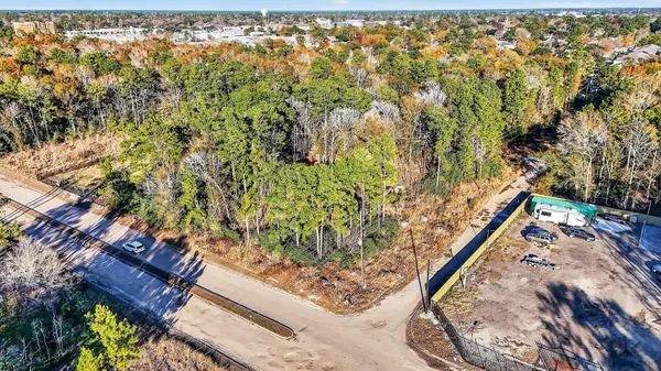 an aerial view of a house with a yard basket ball court and outdoor seating