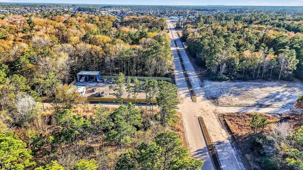 an aerial view of a house with a yard basket ball court and outdoor seating