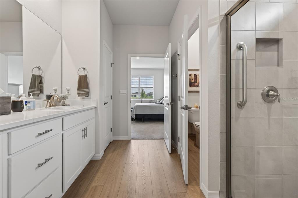 18237 Beach Ranch Terrace Bradenton, FL 34211 - Photo 45 of 72 a en suite bathroom with a sink and a mirror