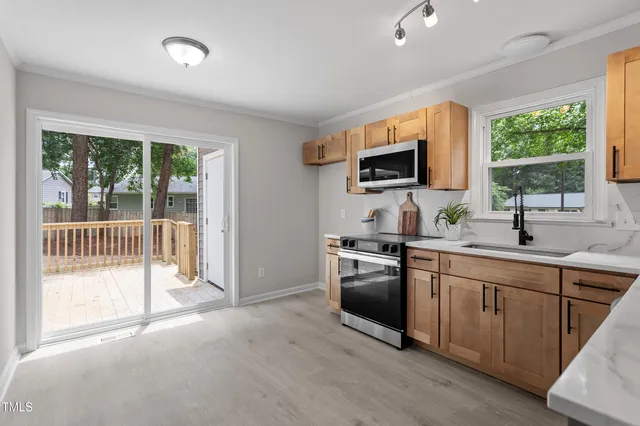 a kitchen with granite countertop a stove and a sink