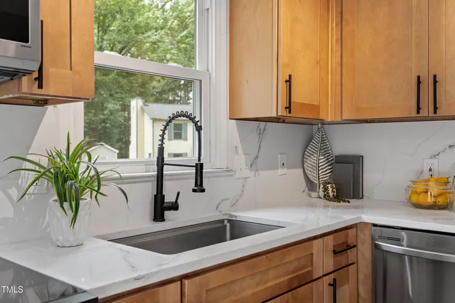 a kitchen with a sink a counter and a window