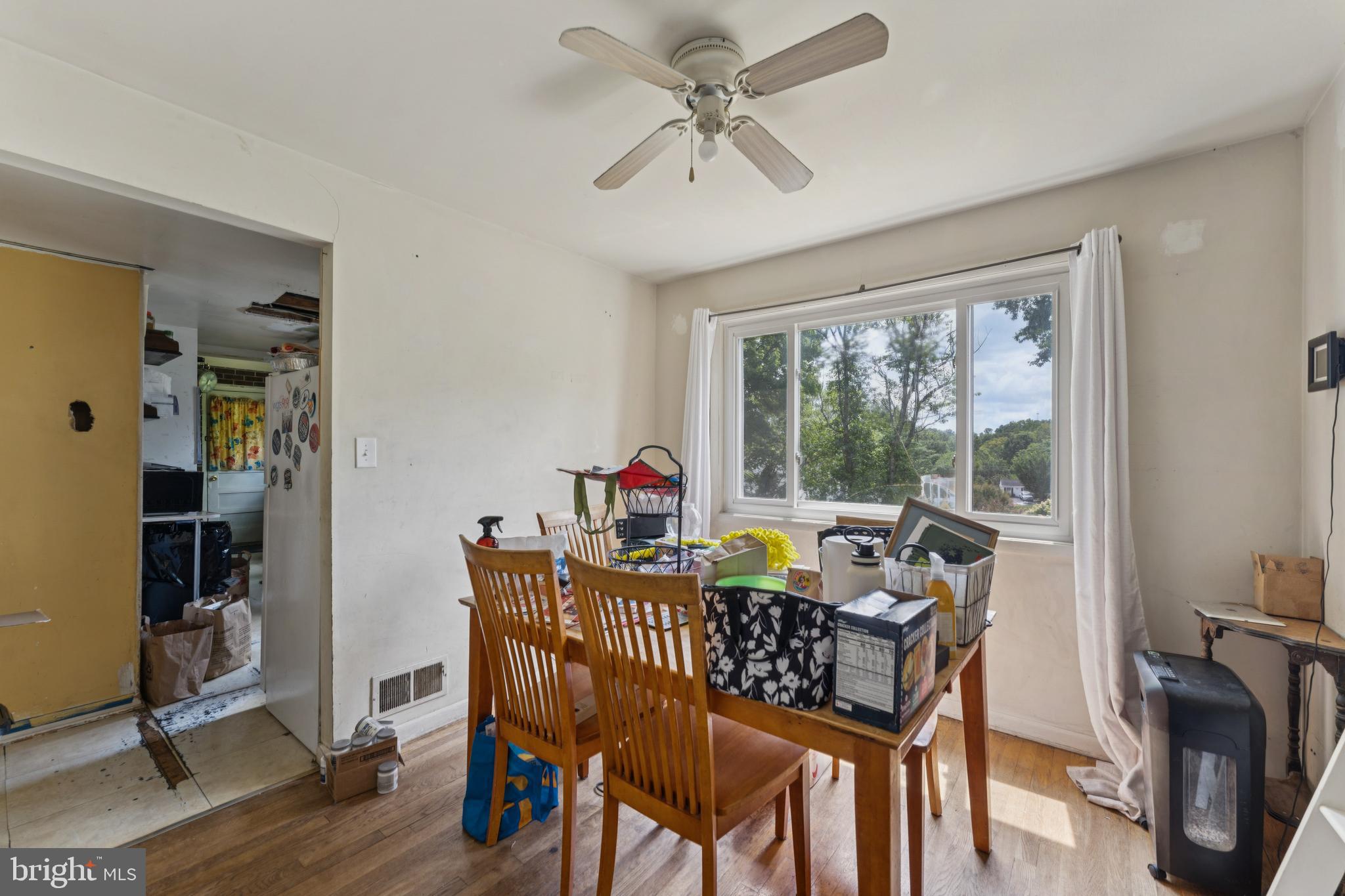 6413 Darwin Road Laurel, MD 20707 - Photo 7 of 17 a view of a dining room with furniture window and wooden floor