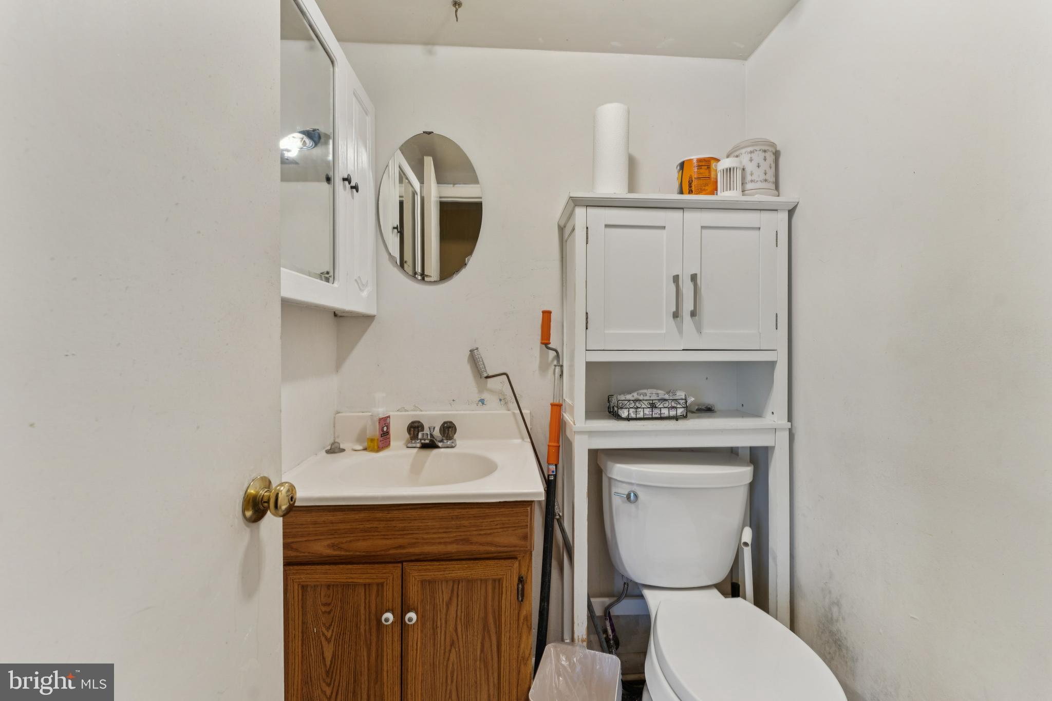 6413 Darwin Road Laurel, MD 20707 - Photo 9 of 17 a bathroom with a toilet sink and mirror