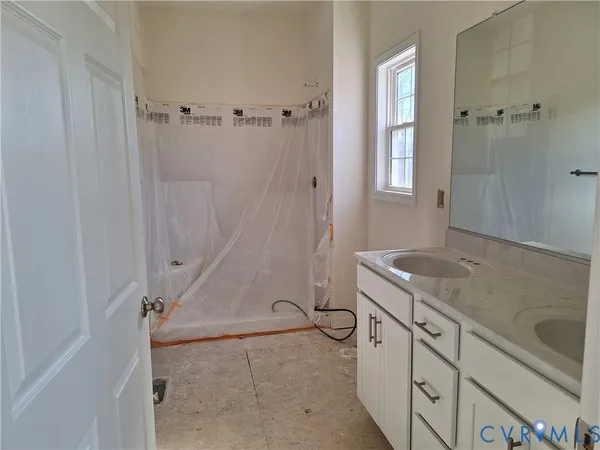 a bathroom with a granite countertop sink a toilet and shower