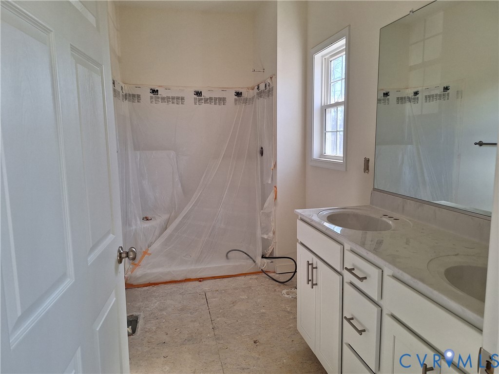 2086 East Courthouse Road Blackstone, VA 23824 - Photo 11 of 12 a bathroom with a granite countertop sink a toilet and shower