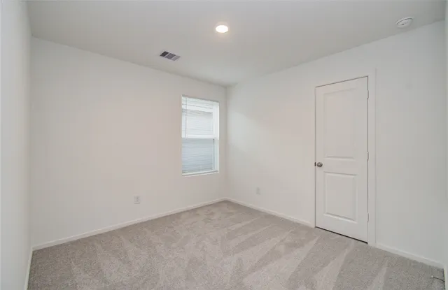 an empty room with a empty space and window