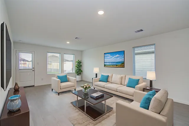 a living room with furniture and a flat screen tv