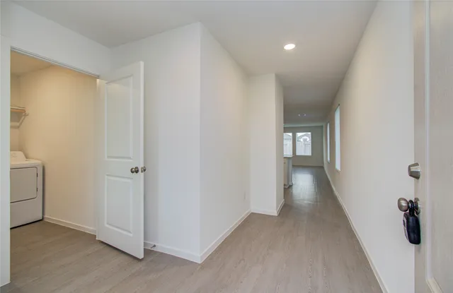 a view of a hallway with wooden floor