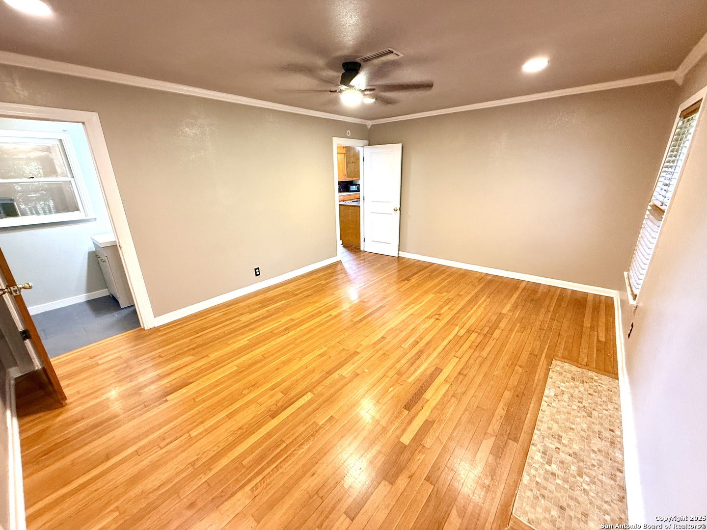 27320 Toutant Beauregard Road Boerne, TX 78006 - Photo 18 of 32 a view of empty room with wooden floor and fan