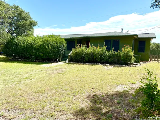 a view of house with swimming pool and outdoor seating