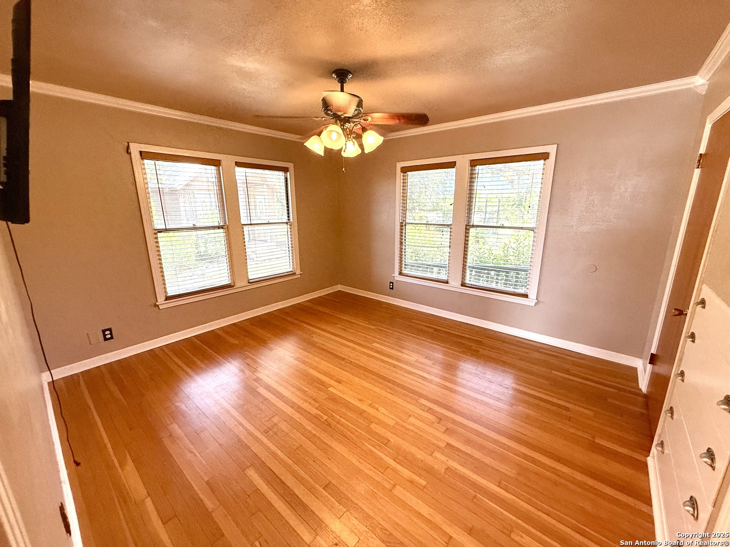 27320 Toutant Beauregard Road Boerne, TX 78006 - Photo 22 of 32 a view of an empty room with wooden floor and a window