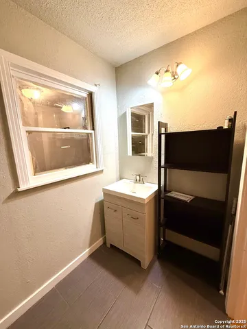 a bathroom with a sink a mirror and a bathtub