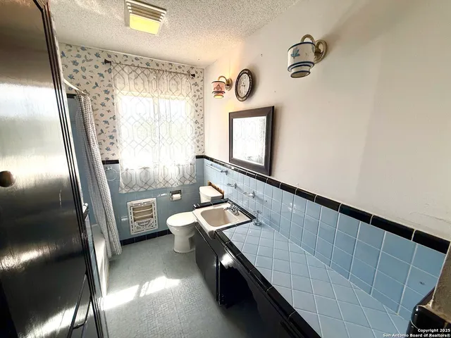 a bathroom with a sink a mirror and a toilet