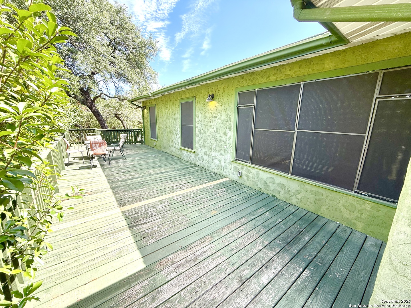 27320 Toutant Beauregard Road Boerne, TX 78006 - Photo 3 of 32 a porch with seating space and hardwood floor