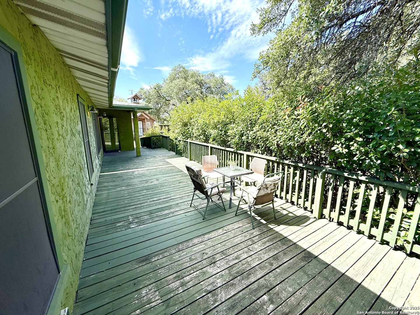 27320 Toutant Beauregard Road Boerne, TX 78006 - Photo 4 of 32 a balcony with wooden floor table and chairs