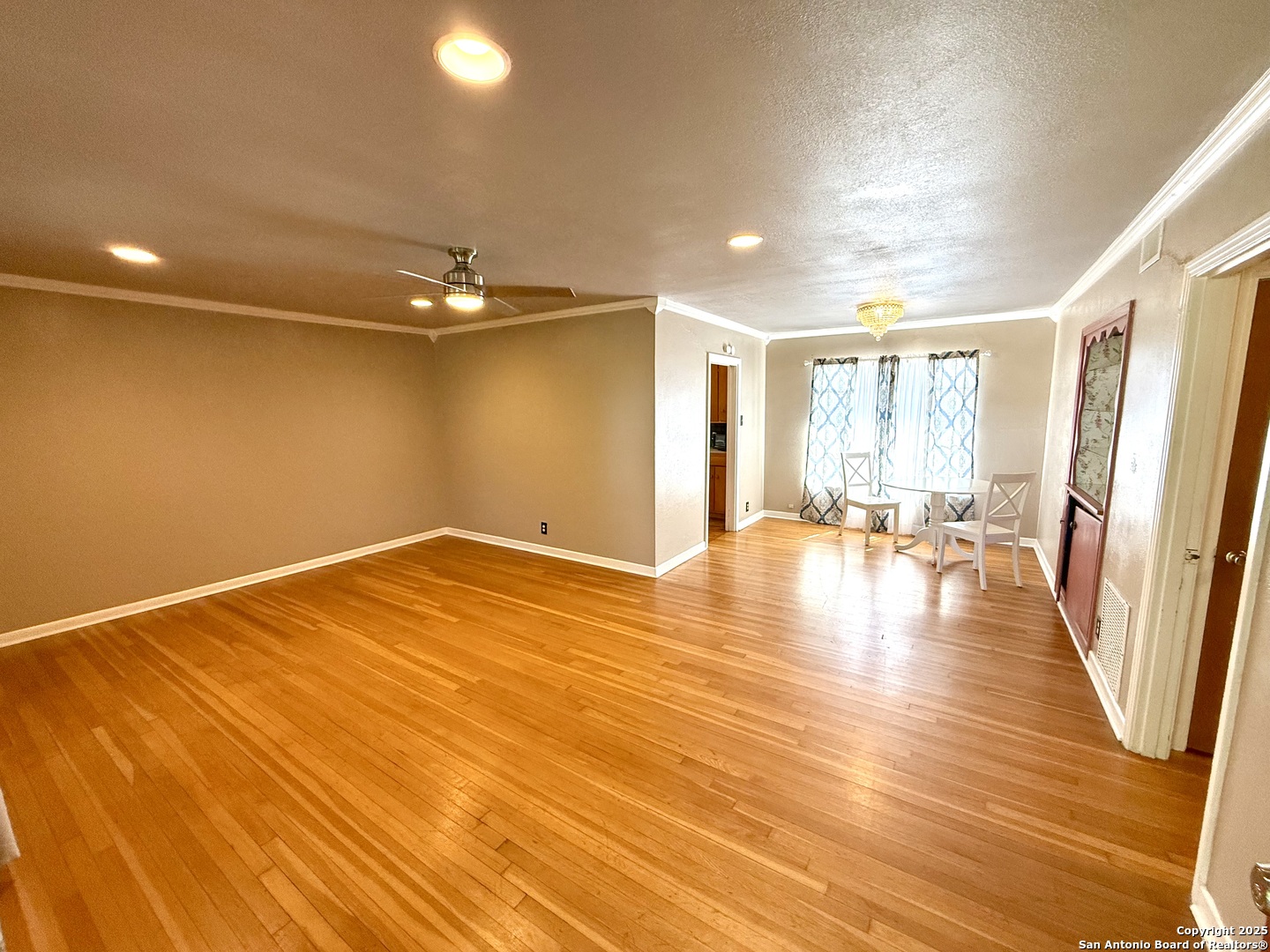 27320 Toutant Beauregard Road Boerne, TX 78006 - Photo 5 of 32 a view of empty room with wooden floor and fan