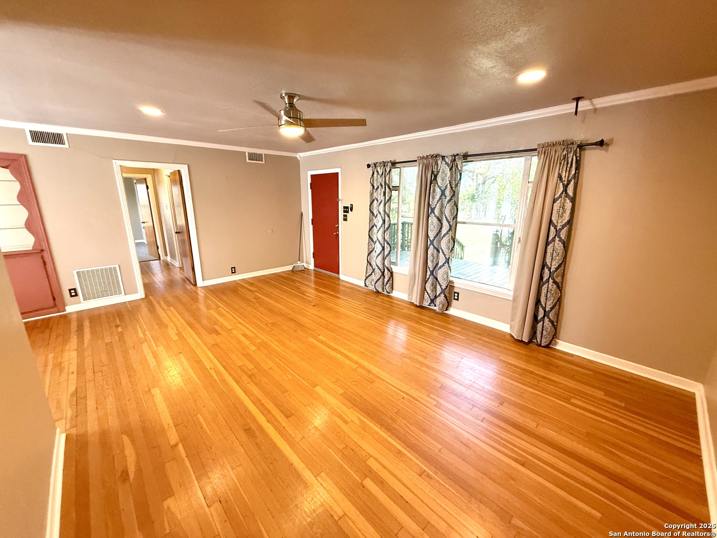 27320 Toutant Beauregard Road Boerne, TX 78006 - Photo 7 of 32 a view of an empty room with wooden floor and a window