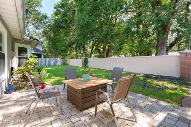 a view of backyard with seating space and trees