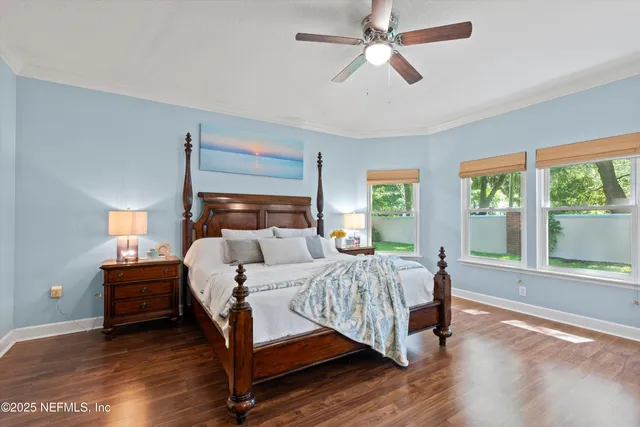 a bed room with a bed and a large window