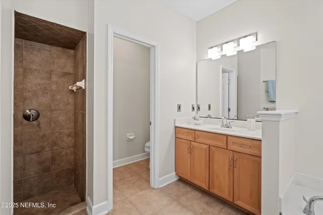 a bathroom with a double vanity sink mirror and shower