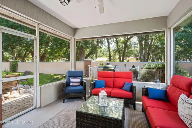 a living room with furniture and a floor to ceiling window