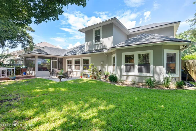 a front view of a house with yard patio and green space