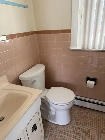 a white toilet sitting next to a bathroom sink