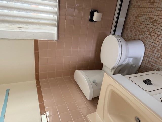 128 Maywood Road Mastic Beach, NY 11951 - Photo 8 of 11 a white toilet sitting next to a bathroom sink