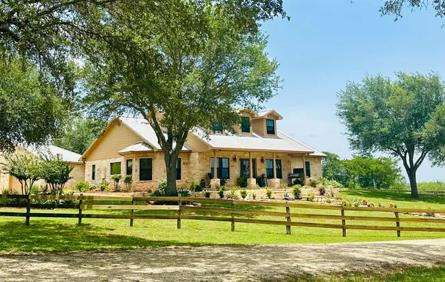 a front view of a house with a yard table and chairs