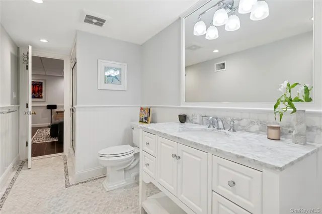 a room with stainless steel appliances lots of counter space and wooden floor